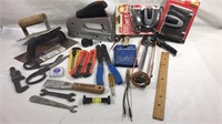 Assortment of hand tools caulk gun stapler