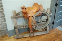 Western Saddle mounted on Antique Wooden Gate