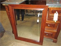 Bevelled mirror in wood frame