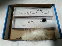 Vintage eye glasses and feather pen