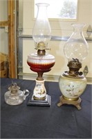 3 oil lamps one is a double wick with brass claw