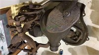2 antique iron machinery pieces, one is a blower