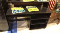 Black laminate desk with pull out tray’s, shelf