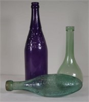 Three early glass bottles