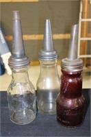 Three glass oil bottles including brown