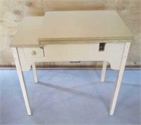 Cream colored sewing machine table