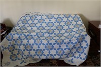 White quilt with blue design