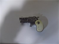 Small Ivory hand cap gun