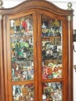 large glass curio cabinet lighted