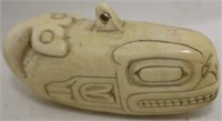 NORTHWEST COAST AMULET IN THE FORM OF A WHALE,
