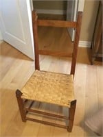 Early primitive antique chair with woven seat.