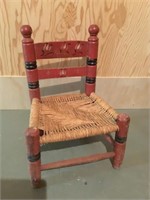 Vintage child’s chair with grass seat.