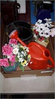 Box of fake flowers watering jug and pot