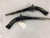 pair of carved replica pistols