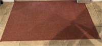 Rust red woven area rug