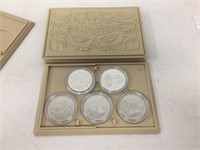 2 sets of 5 coins in cases
