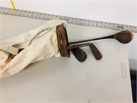 old wood golf clubs with canvas bag