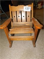 Antique oak child's slatted rocking chair, one