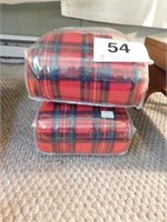 Two red plaid throws in packages