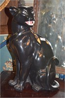 Plaster sculpture of a black panther, hand