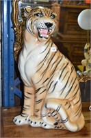 Ceramic glazed tiger sculpture with hand