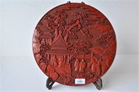Red resin circular panel decorated with scholars