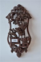 Pierced wooden carving of a potted floral plant,