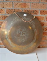 Large brass gong, decorated with a pair of
