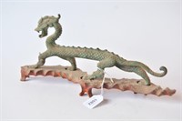 Bronze sculpture of a striding dragon on a custom