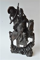 Carved wooden sculpture of a warrior on