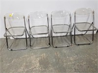 Four Lucite and chrome folding chairs