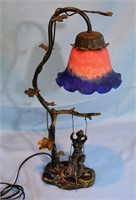 Bronze/metal lady in swing lamp w/colored shade