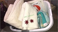 Laundry basket with three quilts and a cozy