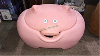 Molded plastic pig toy box with toys and other