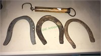 Three unique horseshoes, brass hanging scale, up
