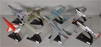 Eight various Amer Die Cast model planes on stands