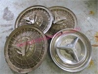 4 old car hubcaps (3 are matching)