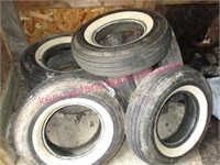 stack of old car tires (many thick whitewalls)