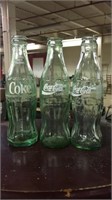 Three Coca-Cola bottles