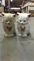 Two clay cat decorations