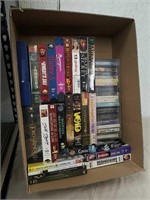 Group of VHS, DVD, and cassette tapes