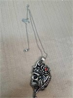 Decorative heavy skull pendant with red gemstone