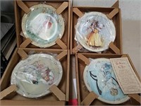 4 collectible plates with COA's look new in boxes