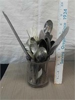 Vintage kitchen utensils in glass vase