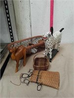 Wood carved camel statue, wicker baskets, and dog