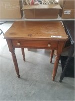 one drawer side table, top is rough