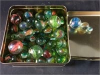 Tin container filled with various size marbles