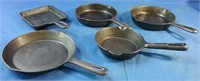 5 assorted size cast iron frying pans