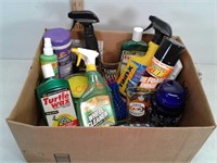 Box of car washing car detailing cleaners and two