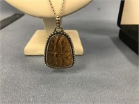 Tiger eye pendent relief carved with geometric des